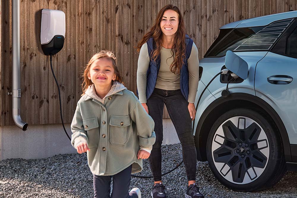Eine Familie hat Spass beim Aufladen ihres elektrischen Ford Explorer zu Hause.