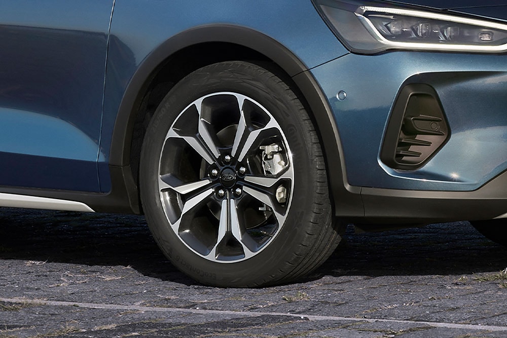 Eine Nahaufnahme der Leichtmetallfelgen eines Ford Focus mit einer dunkelgrauen und silbernen Lackierung.