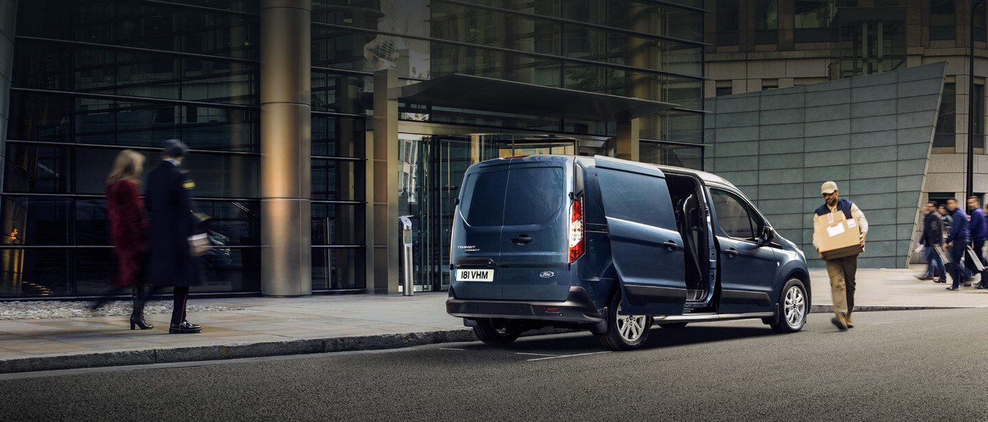 New Blue Ford Transit Connect driving in city New Blue Ford Transit Connect driving in city