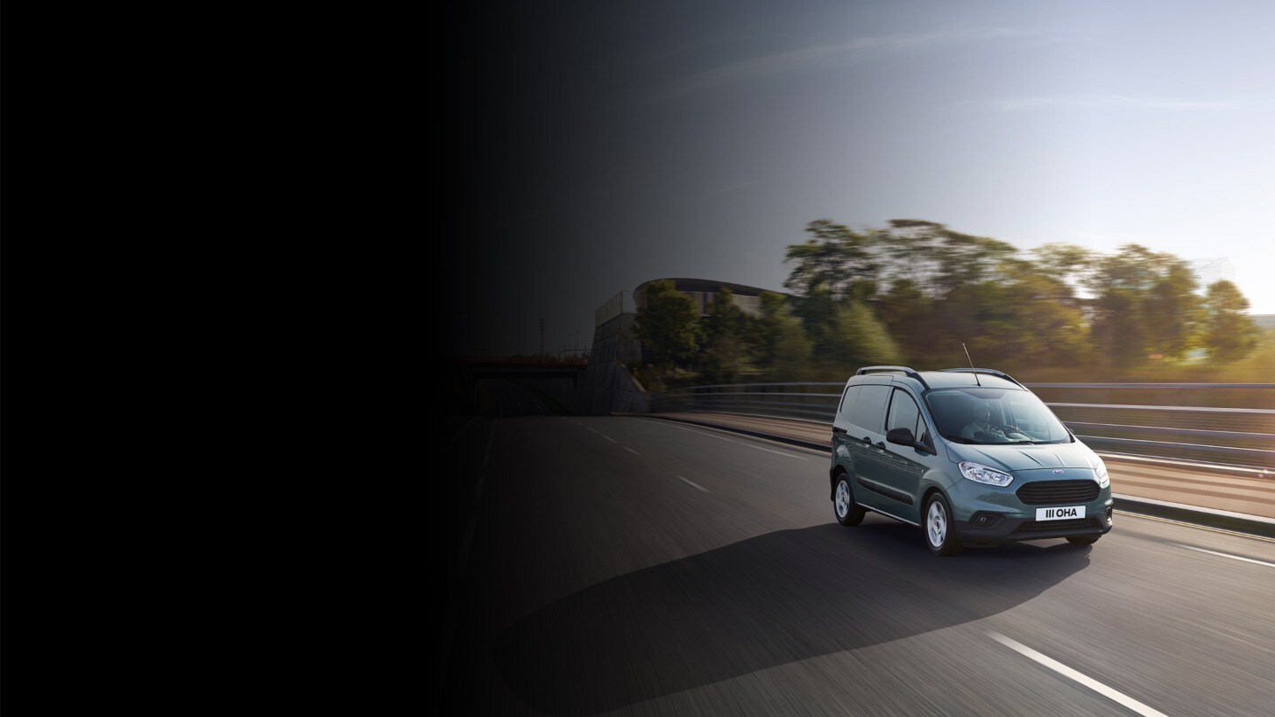 Blue Ford Transit Courier on highway