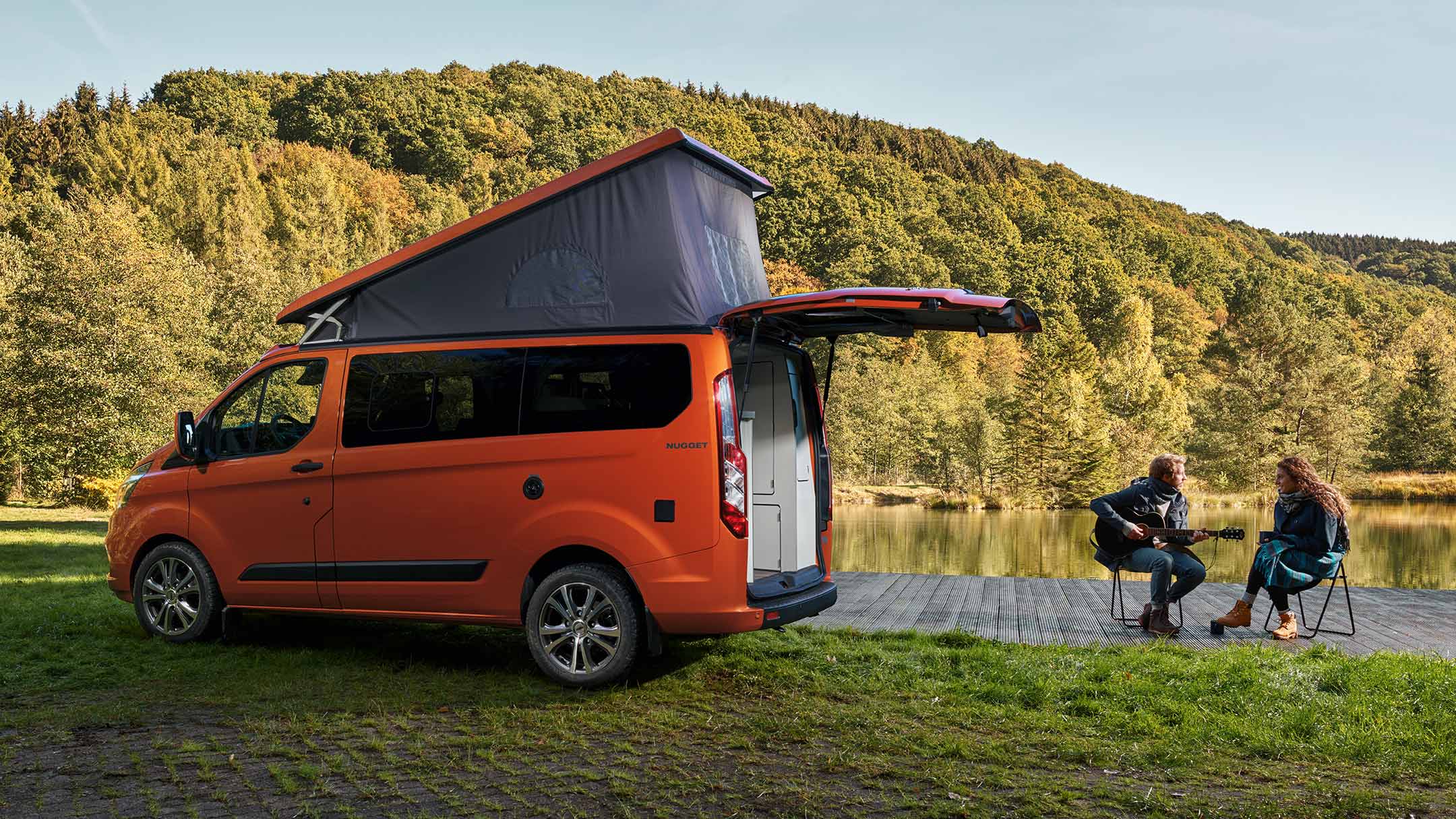 New Orange Ford Transit Custom Nugget side view with raised roof