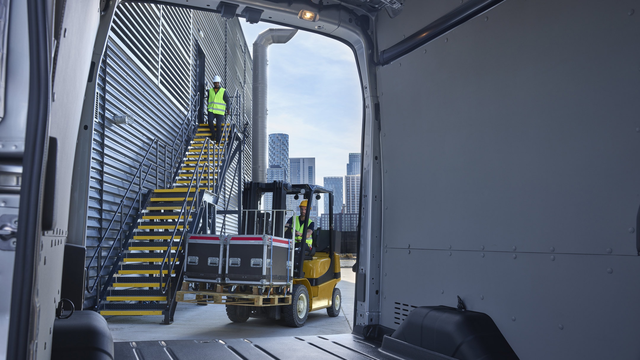 Back of the Ford E-Transit showing space and a person on top of stairs
